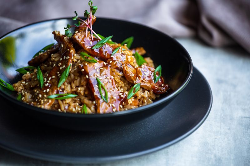 Teriyaki salmon grain bowl with edamame and sesame